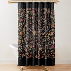 a black shower curtain with flowers and leaves on the outside, in front of a white bath tub