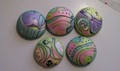 six colorful buttons with designs on them sitting next to each other in the shape of cupcakes