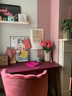 a desk with a pink chair next to it