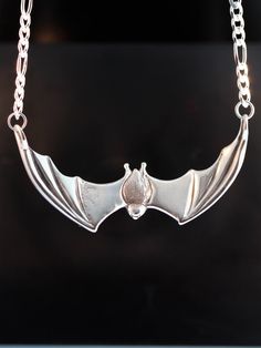 "This striking Bat Pendant is cast in solid sterling silver. It is sculpted both front and back with a wing span is 2 1/4\". A 16\" figaro chain is attached to both wing tips and is included in the price of this piece making the total length of the pendant just over 18\". All Marty Magic Jewelry is packaged in a beautiful box, embossed with the gold foil Marty Magic dragon logo. Perfect for any occasion! Designed in California by Marty Magic. Made in the U.S.A." Bat Clothes, Magic Jewelry, Bat Pendant, Magic Dragon, Dragon Logo, Bat Jewelry, Bat Necklace, Bat Earrings, Jewelry Halloween