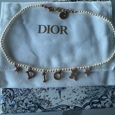 Authentic Dior Pearl Chocker Necklace In Gold. Used But In Brand New Condition Box Included. Luxury White Gold Jewelry With Logo Charm, Elegant White Jewelry With Logo Charm, White Formal Jewelry With Logo Charm, Formal White Jewelry With Logo Charm, Elegant White Necklace With Logo Charm, Designer White Necklaces For Gifts, White Jewelry With Logo Charm For Gift, White Jewelry With Logo Charm As A Gift, White Necklace With Logo Charm For Gift