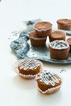 several cupcakes with frosting and sprinkles sitting on a plate