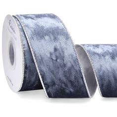 two rolls of blue velvet ribbon on white background