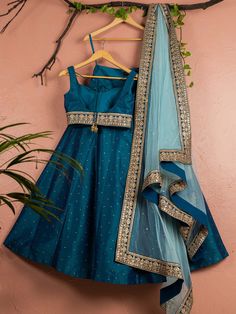 This is a three-piece Peacock Blue lehenga set with sky blue dupatta from the Anisha Shetty collection. This beautiful peacock blue rawsilk stone work lehenga is paired with a raw silk peacock blue embroidered blouse. The peacock blue color with stone work and embroidery enhances this lehenga set. The blouse has a sequin tassel tie-up at the back. The outfit is completed with a net sky blue dupatta with heavy gold embroidery border in peacock blue accent and badla work all over. Blue Art Silk Palazzo Set For Eid, Blue Chanderi Floor-length Palazzo Set, Blue Anarkali Raw Silk Palazzo Set, Blue Anarkali Style Raw Silk Palazzo Set, Blue Chanderi Sets For Reception, Blue Bollywood Art Silk Palazzo Set, Blue Raw Silk Anarkali Set For Diwali, Designer Blue Dola Silk Palazzo Set, Blue Art Silk Palazzo Set For Wedding