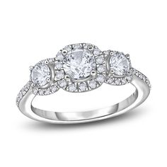 three stone engagement ring with diamonds on the shoulders and sides, set in white gold