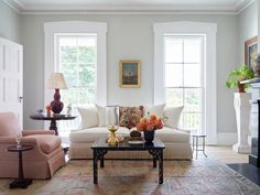 a living room with two couches and a coffee table in front of the fireplace