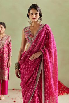 Hot pink georgette saree with all over multi color bandhani resham, sequin work and contrast zardozi hand embroidered border.  Components: 1 Pattern: Hand Embroidered Type Of Work: Sequin, Resham and Zardozi Work Fabric: Georgette  Color: Pink Other Details:  Contrast border Note: The stitched blouse worn by the model and the outfit worn by the other model at the back are not being sold Occasion: Sangeet,Wedding - Aza Fashions Hot Pink Saree Contrast Blouse, Pink Saree Contrast Blouse, Pink Georgette Saree, Pink Saree Blouse, Mrunalini Rao, Saree Georgette, Saree Blouses Online, Zardozi Work, New Saree Blouse Designs