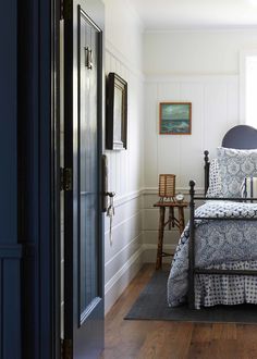 a bed sitting in a bedroom next to a doorway