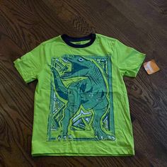 Gymboree Short Sleeve Shirt Nwt Size Medium So Cute With The Dinosaur A Little Boy Will Love This Casual Green Dinosaur Print Tops, Casual Green Tops With Dinosaur Print, Cotton Tops With Dinosaur Print For Spring, Green Dinosaur Print Top For Spring, Green Dinosaur Print Tops For Spring, Green Cotton Dinosaur Print Tops, Green Cotton Tops With Dinosaur Print, Green Dinosaur Print T-shirt For Summer, Green Dinosaur Print Summer T-shirt