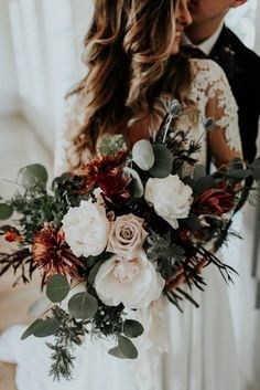 a bride holding a bouquet of flowers in her hands