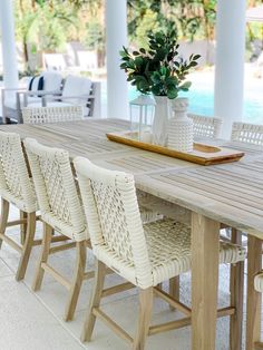 a table with chairs and a tray on top of it next to a swimming pool