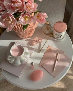 a table topped with pink flowers and other items