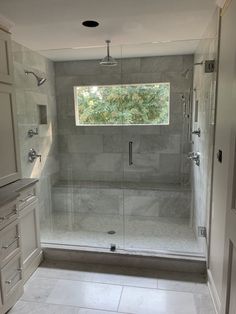 a walk in shower sitting inside of a bathroom