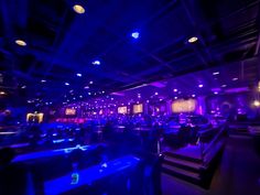 a room filled with lots of tables covered in blue lights