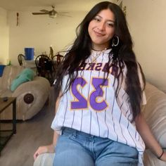 a woman sitting on top of a couch in a living room