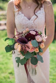 a woman holding a bouquet of flowers in her hands