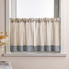 a window with a checkered curtain and matching valance