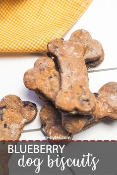 blueberry dog biscuits on a table with a yellow towel and orange napkin