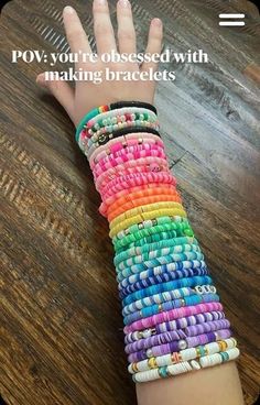 a child's hand holding up a colorful bracelet with words above it that says pov you're obsesed with making bracelets