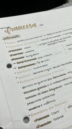 a close up of a menu on top of a white paper with gold foil lettering