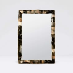 a square mirror sitting on top of a table