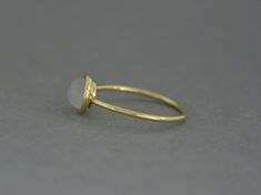 Gold ring with natural moonstone. Made of 585/14k solid gold (yellow, white or rose - your choice). Width 1.2 mm, diameter of central part is 8 mm. Model's ring size on photo is 7US. Gold Wire Ring, Gold Opal Ring, Gold Moonstone Ring, Opal Band, Black Gems, Ring Opal, Carnelian Ring, Opal Ring Gold, Etsy Gold Ring