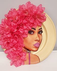 a plate with pink flowers on it and an image of a woman's face