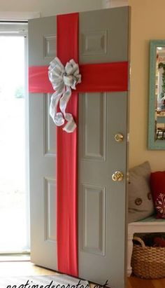 a door decorated with red ribbon and a bow