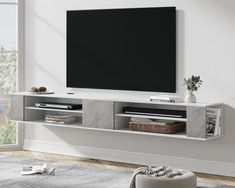 an entertainment center with a flat screen tv mounted on the wall