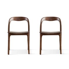 two wooden chairs sitting next to each other