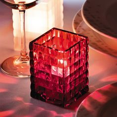 a red glass sitting on top of a table