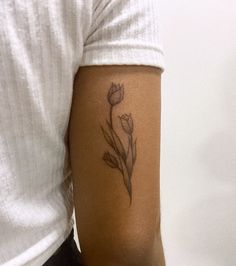 a person with a flower tattoo on their arm