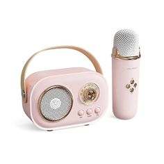 a pink radio with a gold handle next to it and a microphone in front of it