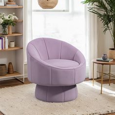 a purple chair sitting on top of a rug in a living room next to a window