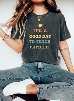 Celebrate a love of learning with our delightful It's A Good Day to Teach Phys. Ed. Teacher Shirt! This adorable t-shirt is the perfect blend of cuteness and educational enthusiasm, making it an ideal gift for Physical Education teachers and a must-have for PE teacher teams gearing up for back-to-school season. Sure to be a favorite for teacher appreciation, gift giving, team t-shirts, and more! The breathable material ensures all-day comfort, while the durable construction ensures that this shi Third Grade Teacher Shirts, Its A Good Day, Physical Education Teacher, Love Of Learning, Teaching Third Grade, Homeschool Teacher, Kindergarten Teacher Shirts, Female Teacher, Teacher Team