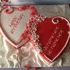 two heart shaped cakes with happy new year written on the top and one is red