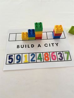 legos are arranged on top of a white sheet with numbers and blocks in the middle