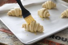 brushing croissants with egg wash