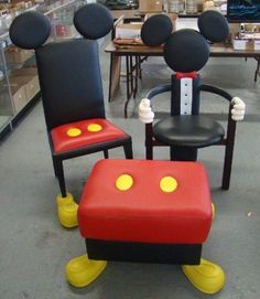 two mickey mouse chairs sitting next to each other in a room with tables and chairs