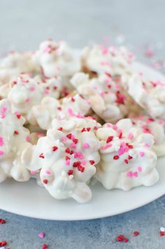 some white and pink sprinkles on a plate