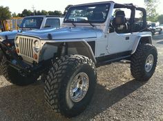 a white jeep parked in a parking lot