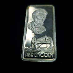 a silver bar with an image of abraham lincoln on it's side, in the dark