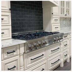 a kitchen with white cabinets and an oven