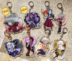 six cartoon keychains with different characters on them