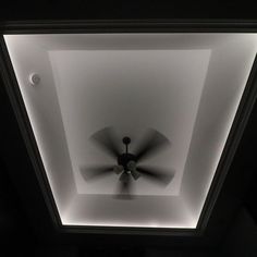 a black and white photo of a ceiling fan