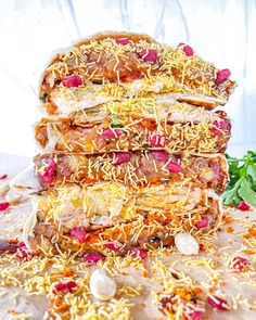 a pile of food sitting on top of a table covered in cheese and other toppings