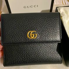 Compact Gucci French Flap Wallet Crafted In Black Grained Leather, Accented With A Tonal Interior And Finished With Antiqued Gold-Tone 'Gg' Logo. Rarely To Never Used. I Just Want A Smaller Wallet #Momprobs. Comes With Box, Dustbag And Tags. Smoke Free. Pet Free Home. It’s About 4.5x4.75 Wallet Craft, Gucci Marmont, Gg Logo, Small Wallet, Antique Gold, Black Color, Wallets, Dust Bag, Gold Tones