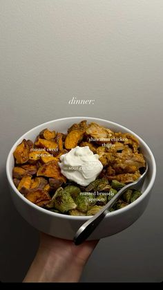 a hand holding a white bowl filled with different types of food and the words dinner above it