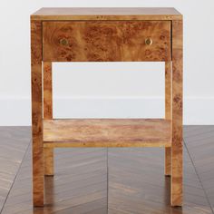 a small wooden table with two drawers on one side and an open drawer on the other