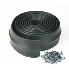 a black rubber seat cushion with screws and bolts on the bottom, set against a white background